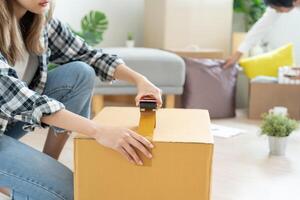 Moving house, relocation. Couple help set and move furniture for new apartment, inside the room was a cardboard box contain personal belongings. move in the new apartment or condominium photo