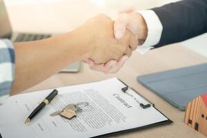 lease, rental and selling home. Dealership manager smile handshake to the new homeowner. rent house, Sales, loan credit financial, insurance, Seller, dealer, installment photo