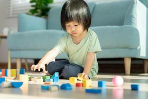 Happy Asian child playing and learning toy blocks. children are very happy and excited at home. child have a great time playing, activities, development, attention deficit hyperactivity disorder photo