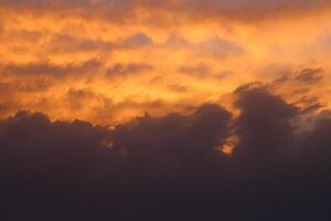 a sunset with clouds and a sunset in the background photo