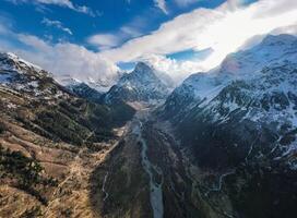 Panoramic breathtaking view of the snow-capped mountains in Dombai photo