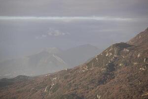 Spring in the mountains, beautiful mountain landscape. View of a mountain range and green trees. Landscape in the haze. Sands of the Sahara. Budva, Montenegro. Europe. Horizontal photo