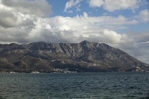 Spring in the mountains, beautiful mountain landscape. View of the mountain range and green trees. Summer, autumn and winter. Budva, Montenegro. Europe. Background. For text. Banner. Postcard. photo