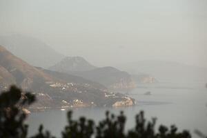 Spring in the mountains, beautiful mountain landscape. View of a mountain range and green trees. Landscape in the haze. Sands of the Sahara. Budva, Montenegro. Europe. Horizontal photo