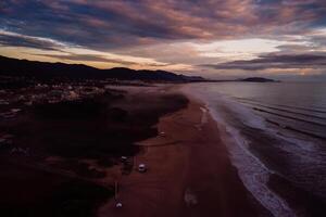 Campeche beach and ocean with sunrise or sunset in Florianopolis photo