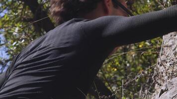 Expert Climber Engages with Challenging Rock Face. A Portrait of Focus and Expertise in High-Quality 6K Slow Motion Footage video