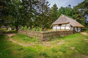 Traditional thatched house Kluki Poland photo