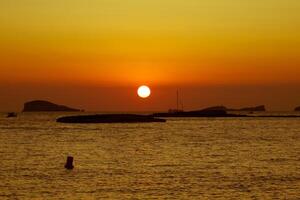 Sunset at the beach cala conta,Ibiza,Spain photo