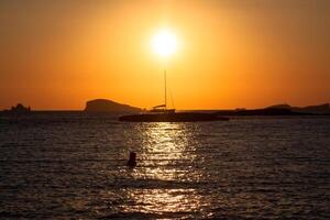 Sunset at the beach cala conta,Ibiza,Spain photo