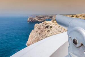 High cliffs and blue ocean at Cabo Sao Vicente on coast of Portugal photo