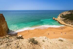 A view of beach in Benagil fishing village on coast of Portugal photo