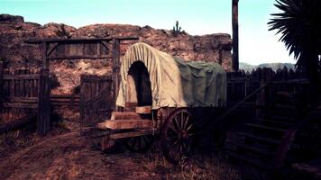 A vintage covered wagon in a rustic countryside setting photo