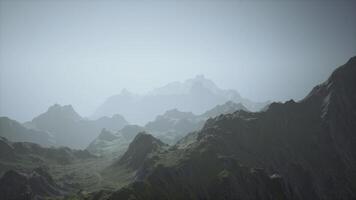 A foggy mountain range in the mist photo