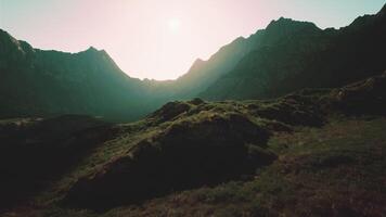 The sun is shining over a mountain range photo