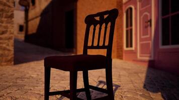 A wooden chair sitting on top of a cobblestone street photo