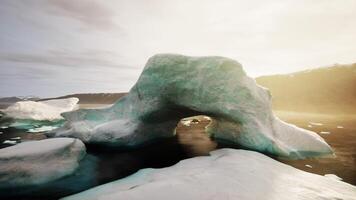 A large iceberg in the middle of a body of water photo