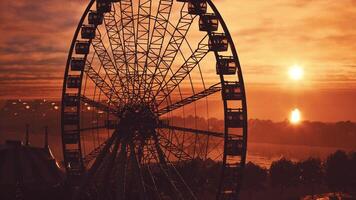 Ferris Wheel Silhouetted Against a Sunset photo