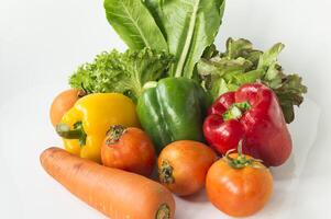 a bunch of vegetables on a white surface photo