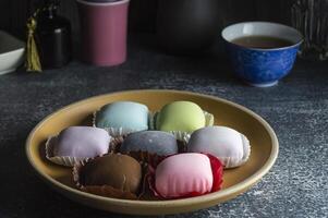 a bowl of different colored chocolates on a table photo