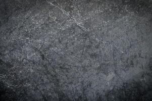 Black or dark gray rough grainy stone texture background photo