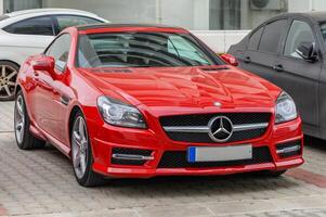 Gaziveren Cyprus 04.24.2024-red Mercedes Benz SLK 250 in the parking lot near the house 3 photo