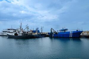 LIMASSOL, CYPRUS - APRIL 15, 2024 Old port of Limassol with beautiful fishing boats at sunset photo