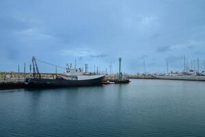 LIMASSOL, CYPRUS - APRIL 15, 2024 Old port of Limassol with beautiful fishing boats at sunset photo