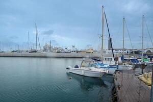 LIMASSOL, CYPRUS - APRIL 15, 2024 Old port of Limassol with beautiful fishing boats at sunset photo