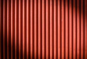 The texture of the fence made of red profiled sheet. Background. Space for text. photo