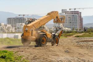 yellow front loader goes to a construction site 2 photo