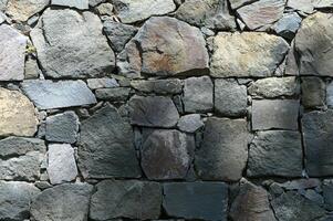 Stone wall texture background - grey stone with different sized stones photo