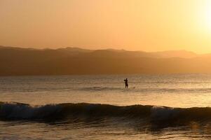 SUP boarding lesson on the Mediterranean sea in winter at sunset 3 photo