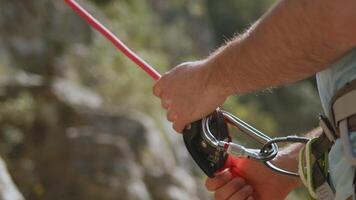 Climber's Hands on Red Rope with Carabiner, Essential Safety Focus in Rock Climbing. video