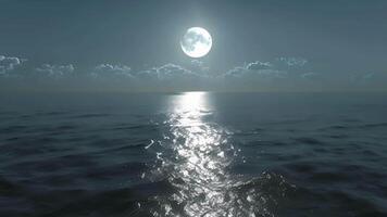 The silver rays of the moon dance across the ocean creating a shimmering pathway towards the horizon video