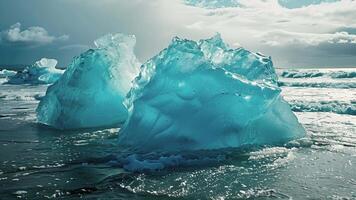 The ocean is filled with dazzling blue icebergs each with their own unique shape and size video