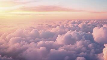 A sea of multicolored clouds at sunset casting a warm glow over the landscape below video