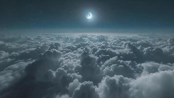 The moon shining through a sea of clouds creating an ethereal glow in the night sky video