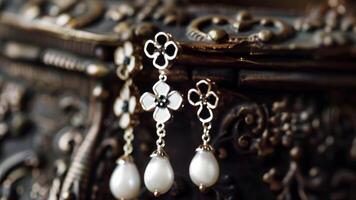 A pair of jet and pearl earrings featuring dangling pendants in the shape of forgetmenot flowers and small black crosses representing remembrance and faith in the afterlife. 2d flat video