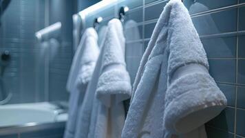 Soft fluffy towels and a plush bathrobe hang on hooks nearby ready to wrap the person in warmth and comfort after their bath video