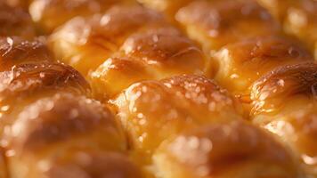 A closeup of a stillwarm brioche bread with its delicate swirls coated in a shiny honey glaze video