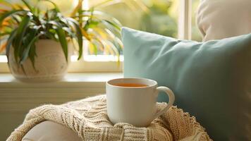 A quiet reading nook is highlighted by a warm mug of freshly brewed herbal tea adding depth and relaxation to the surrounding space video