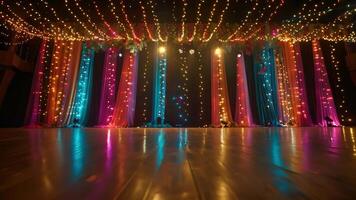 A shot of the stage decorated with ling lights and colorful streamers creating a fun and festive atmosphere video