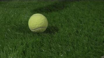 Super Slow Motion Shot of tennis ball and tennis racket at 1000 fps at natural grass during rain. Sport concept super slow motion shot on high speed camera 1000 fps. video