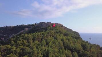 ANKARA, TURKEY - FEBRUARY 25, 2022. Top view of a city in Turkey on a hill during the day. CLIP. A beautiful suburb in the forests with a Turkish flag. Filmed on a quadcopter from above video