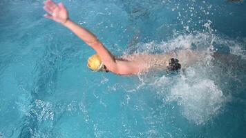 Underwater view of professional swimmer training in swimming pool, 4k 120 fps super slow motion raw . Triathlete swim in black wetsuit video