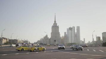 Beautiful city on background of MSU building on sunny day. Action. Lively summer city on background of large white building. Lively city on sunny summer day video