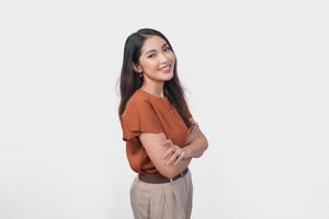 Smiling Asian woman in brown t-shirt standing with confidence expression and looking at the camera isolated over white background. photo