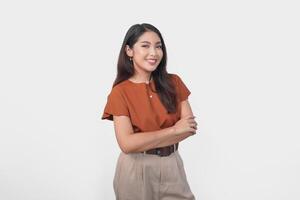 Smiling Asian woman in brown t-shirt standing with confidence expression and looking at the camera isolated over white background. photo