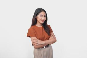 Smiling Asian woman in brown t-shirt standing with confidence expression and looking at the camera isolated over white background. photo