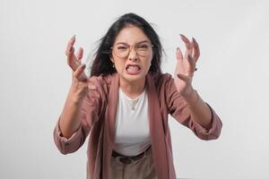 Irritated Asian woman in glasses expressing annoyed, mad, frustrated feelings isolated over white background. photo